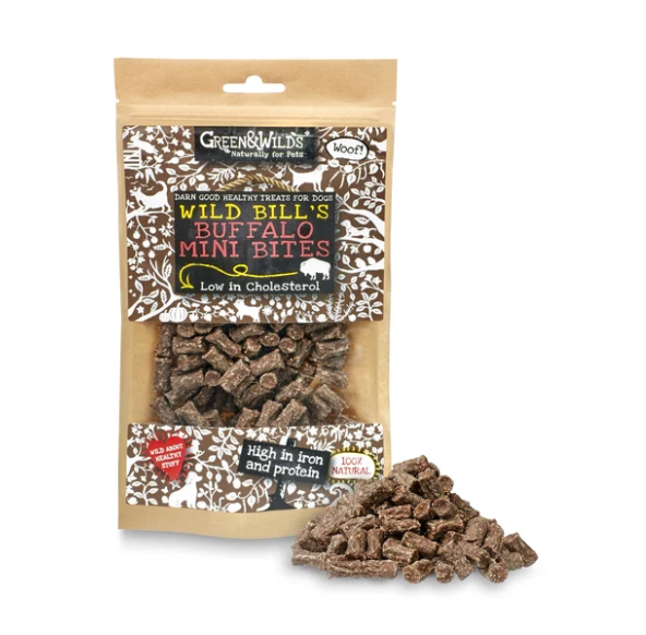 A bag of Greens & Wilds Buffalo Mini Bites dog treats with a small pile of the brown treats displayed in front on a white background.