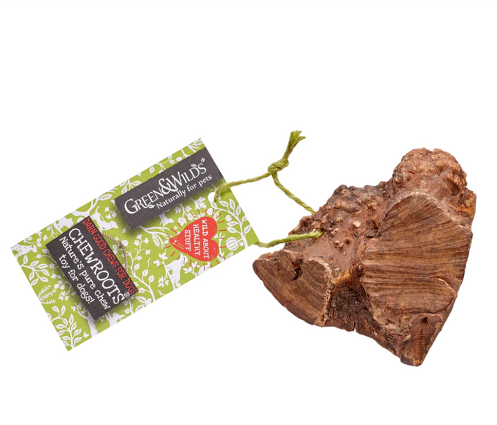 A natural wood dog chew toy, attached to its packaging which has 'Green & Wilds' branding.