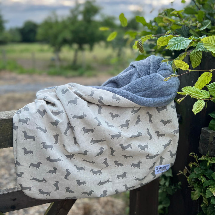 Snuggle sack in dachshund patterned fabric, with dark grey super soft inner. 