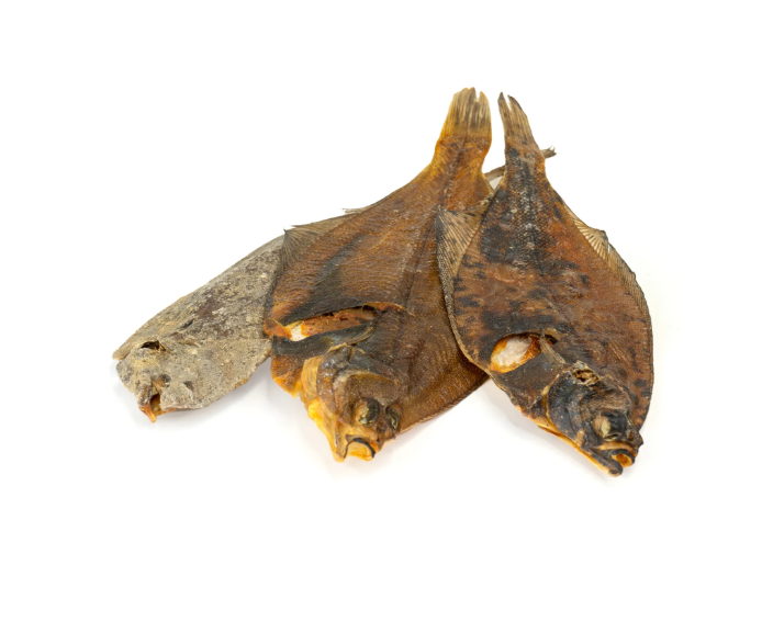Individual dried sole fish on a white background