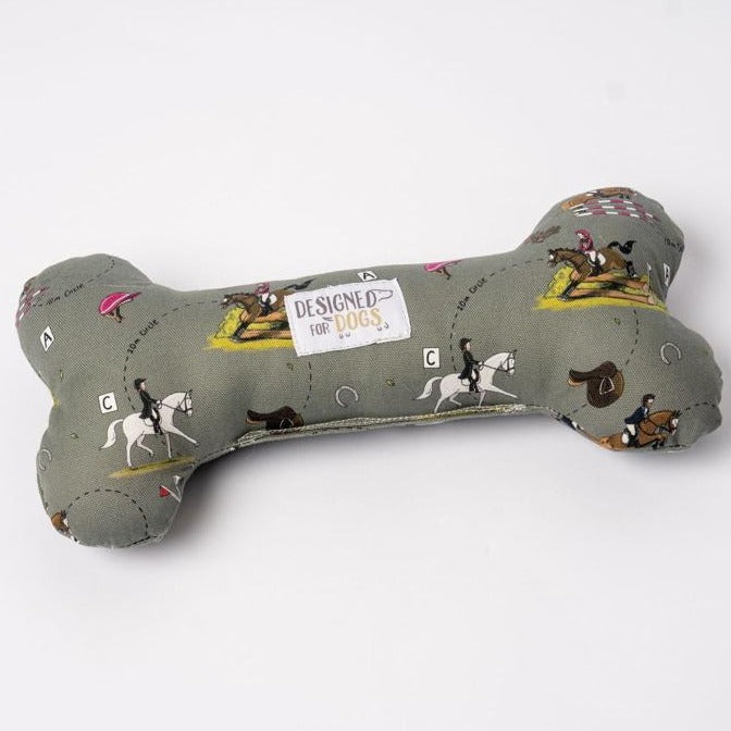 A Designed for Dogs bone toy in the fabric Emily Cole Eventer (light green with horse jumping depicted)
