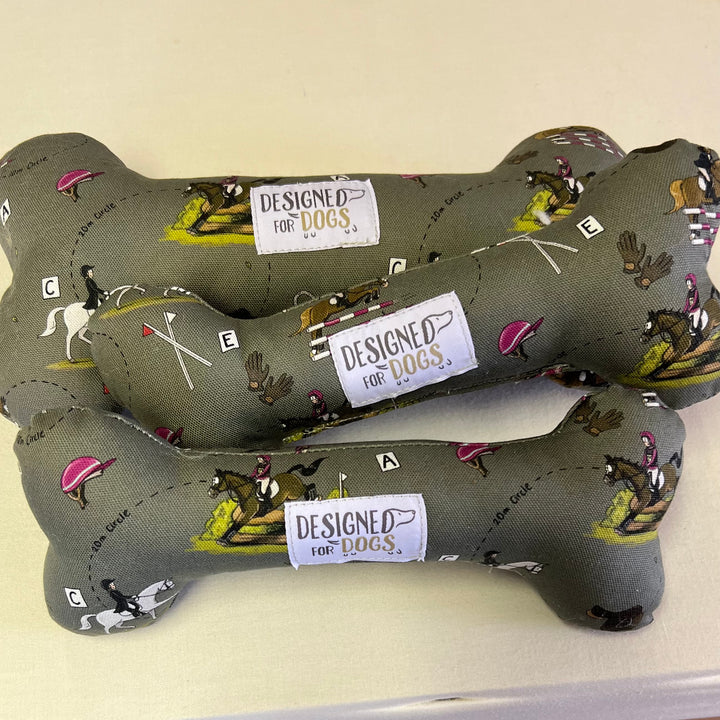 A Designed for Dogs bone toys in the fabric Emily Cole Eventer (light green with horse jumping depicted)