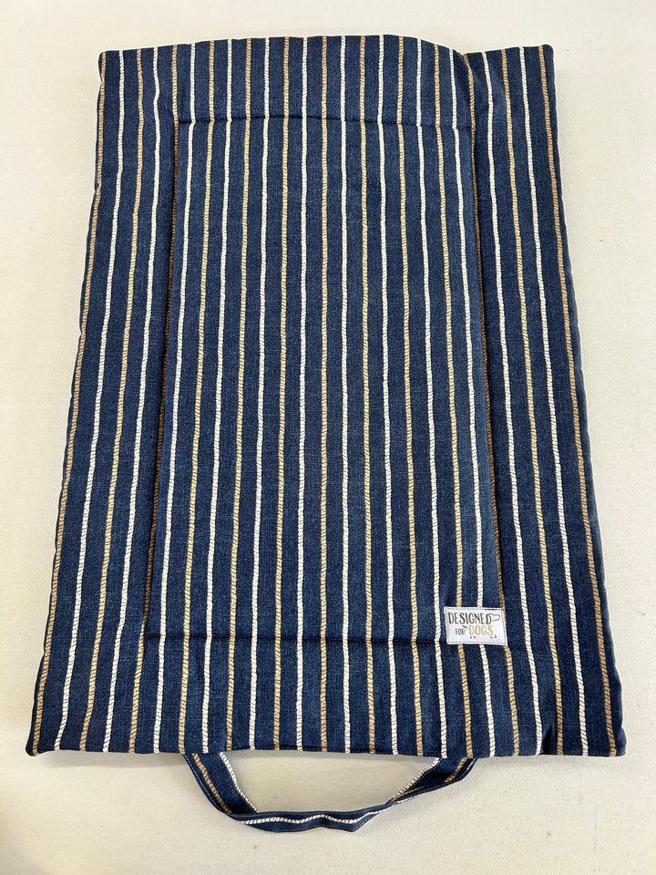 A fabric storage bag or organizer with vertical navy blue, white, and beige stripes, featuring a top handle and a small white brand label that reads 'KASUOJI'.