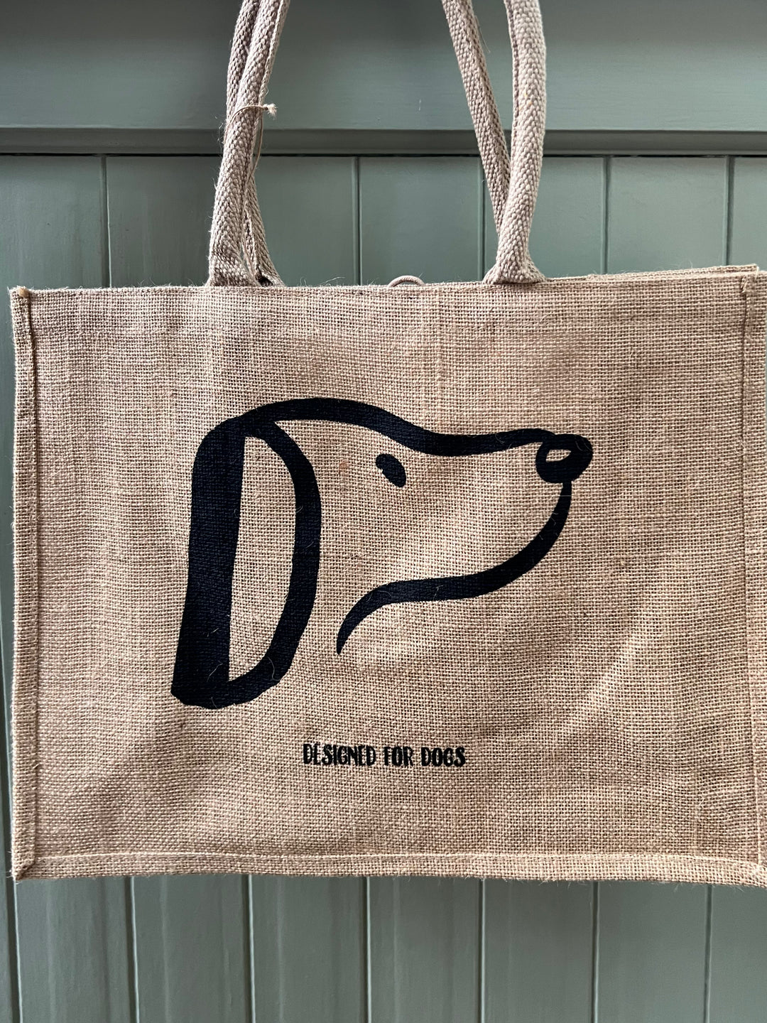 Woven fabric brown shopping bag with black DesignedforDogs logo on it 