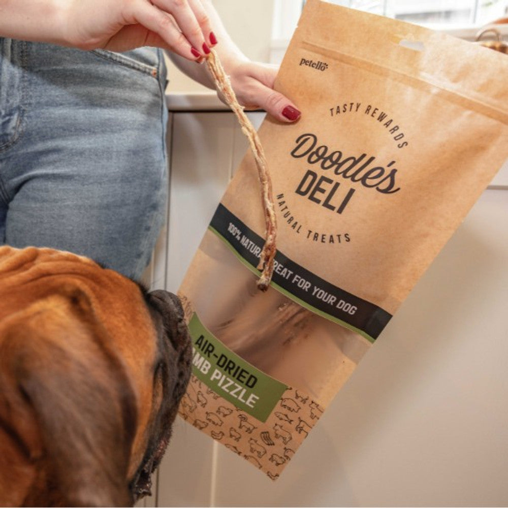 Doodle's deli air-dried lamb pizzle packaging with a dog looking at the product