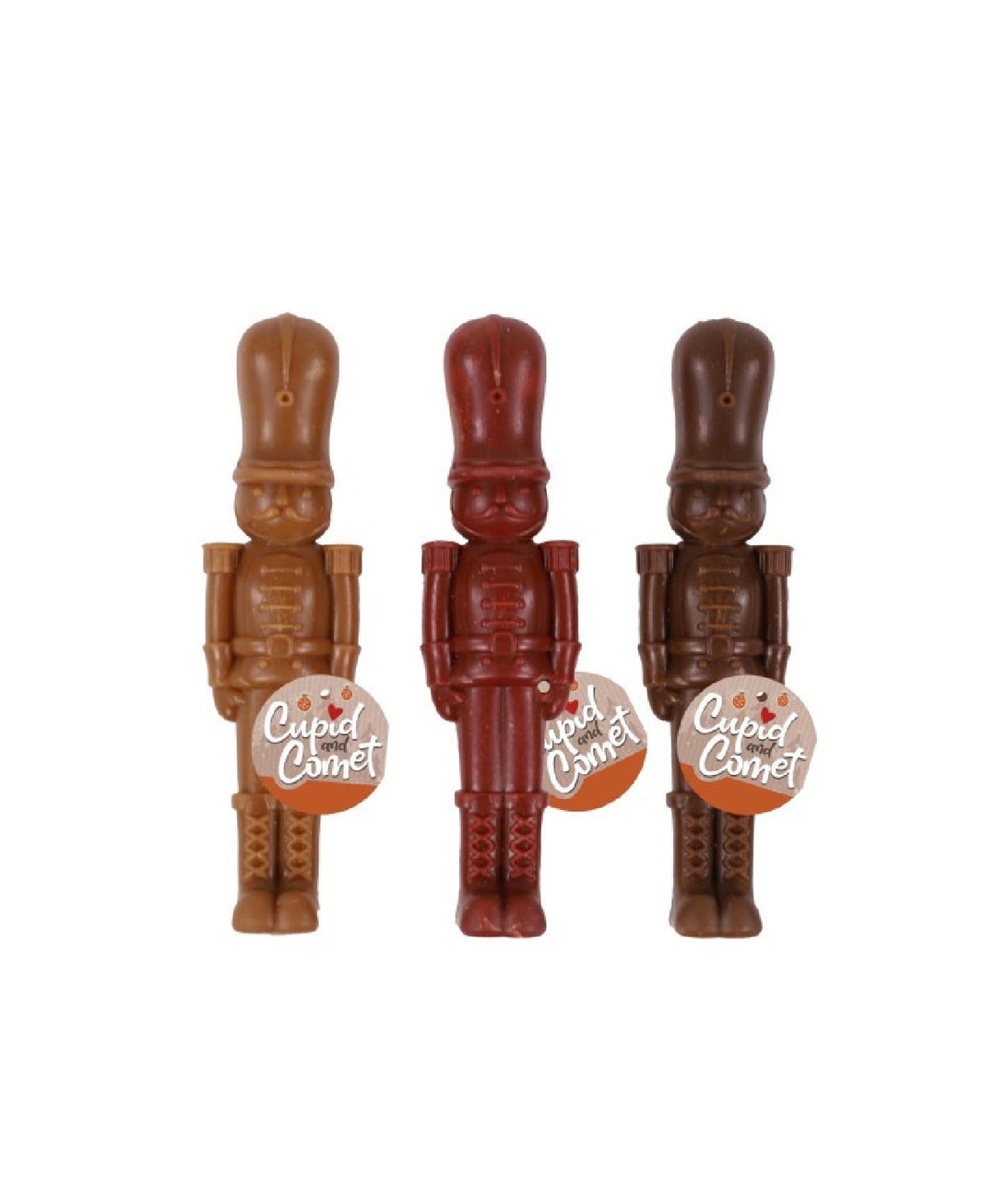 Three different colours of nutcracker shaped dental dog treats with a label that says 'Cupid and Comet'