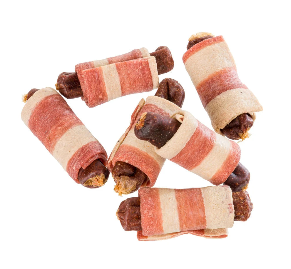 Bacon-wrapped dog treats on a white background