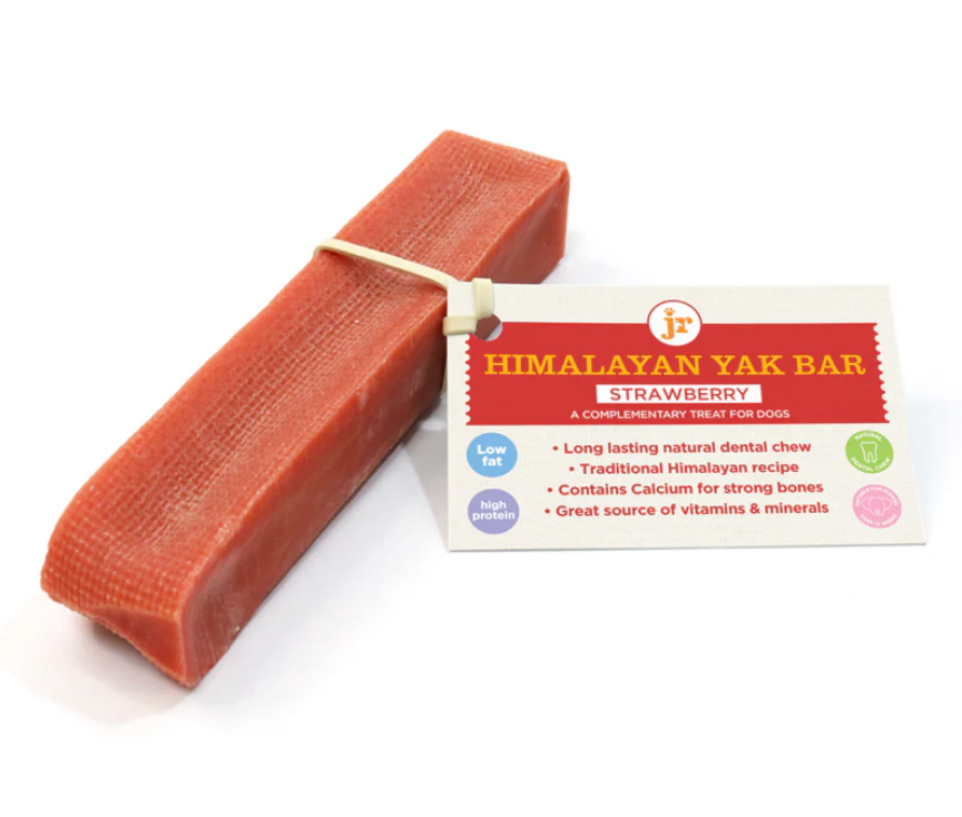 Himalayan Yak Bar strawberry treat for dogs with packaging. Rectangular, red bar dog treat stick