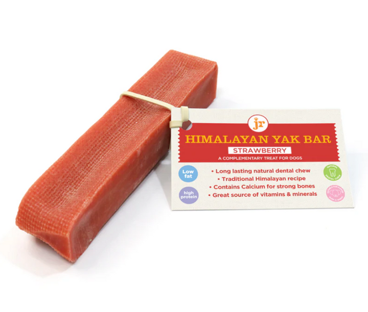 Himalayan Yak Bar strawberry treat for dogs with packaging. Rectangular, red bar dog treat stick