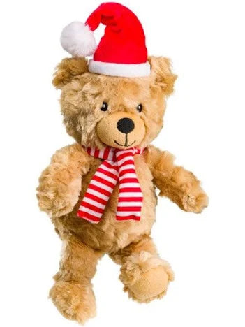 A plush teddy bear in light brown fur wearing a red Santa hat with a white pom-pom and a red-and-white striped scarf, shown against a plain white background.