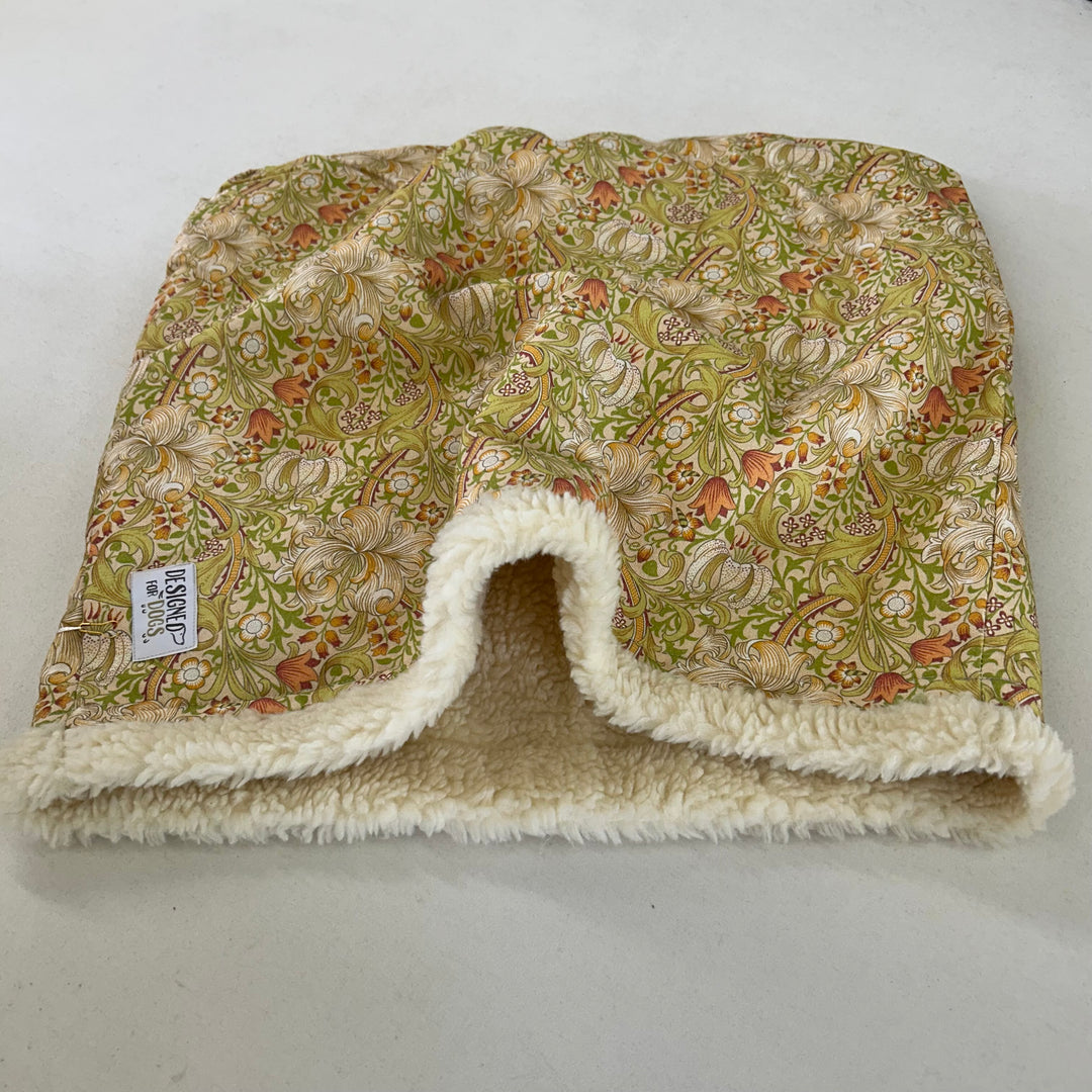 Snuggle sack in yellow William Morris fabric and cream faux sheepskin inner. Fabric shows green/ yellow flowers