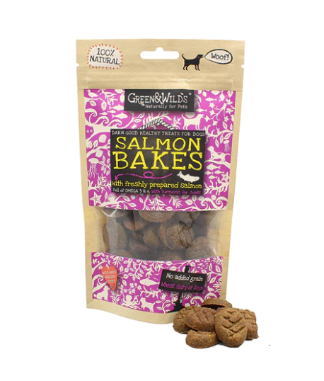 Packaging for Green and Wild Salmon Bakes with a clear window showing the treats inside. The packaging is predominantly pink and black with text and a dog symbol logo.