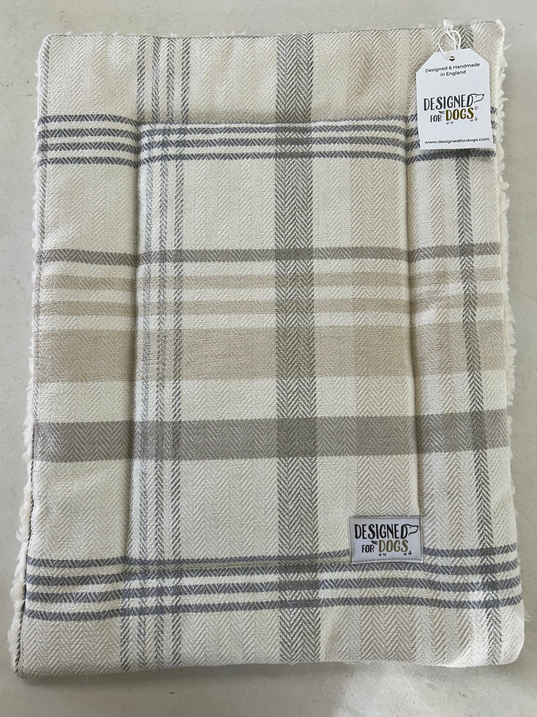 Extra small grey/ beige tartan dog mat with a designed for dogs label 